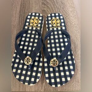 Tory Burch, blue and white flip-flop sandals. Gold detailing.